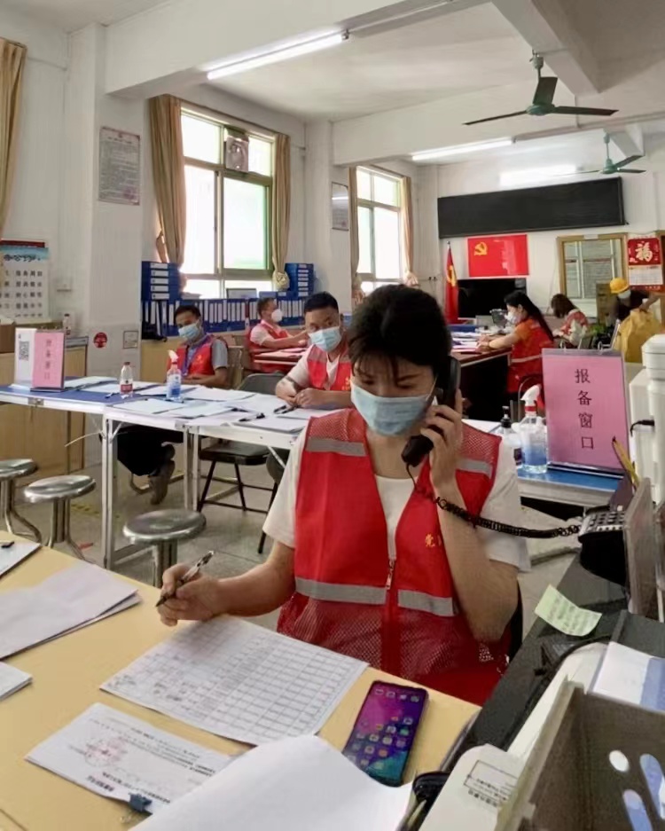 吴菲菲在社区居委接听咨询电话和重点人群报备.jpg
